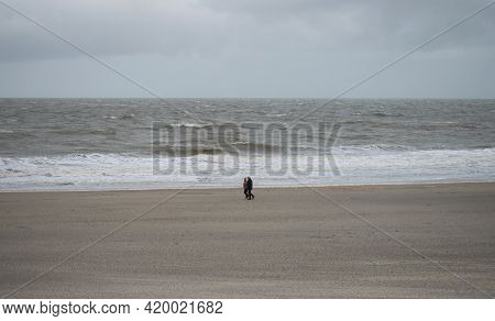Panorama View Of Elderly Couple Walking Along Sand Beach Near Westkapelle Domburg Veere Zeeland Neth