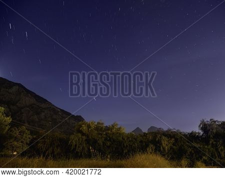 Traces Of Stars Moving In The Night Sky Upon Mountains In Beldibi, Turkey, Panorama Of Starry Sky Ov