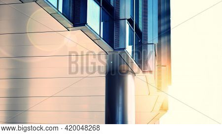 Modern Building In The City With Sunlight. Abstract Texture And Blue Glass Facade In Modern Office B