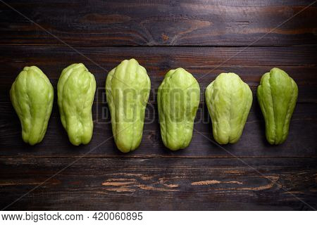 Chayote Squash Fruit (mirliton, Pipinola Or Choko) On Wooden Background, Edible Fruit Eaten Both Coo