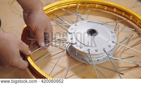 Technician Man Working Motorcycle Wheel Has Spokes Weave Up On Mechanic New Steel Wheel, Motorcycle 