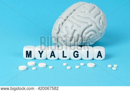 Medicine And Health. Cubes Lie On The Table Among The Pills And Imitation Of The Brain. The Text On 