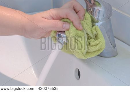 The Process Of Daily Cleaning The Sink With Washing Powder And Household Rag. A Housewife With Hand 