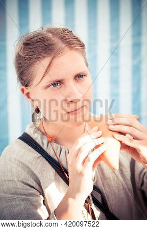 Moscow, Russia - June 23, 2013: Girl In Period Slavic Garments Playing Penny Whistle During Great In