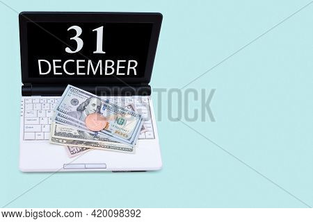 31st Day Of December. Laptop With The Date Of 31 December And Cryptocurrency Bitcoin, Dollars On A B