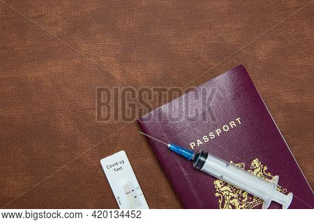 Covid-19, Travel And Lockdown Concept, Passport With Negative Rapid Test And Syringe For Requirement