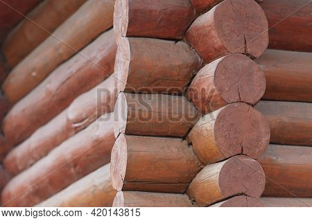 Frame Log Wooden House. A Fragment Of The Wall Of The House, Built Of Round Wooden Logs And Painted 
