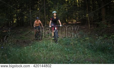 Two Girls On Mtb Bikes. Mother And Daughter Riding On A Forest Trail.