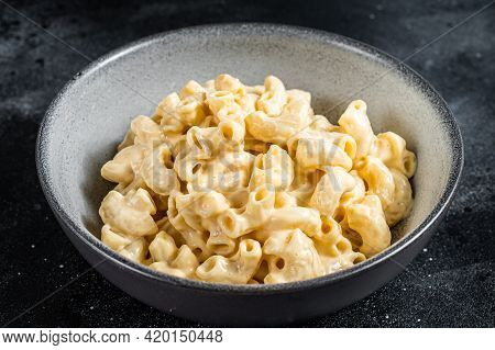 Mac And Cheese American Macaroni Pasta With Cheesy Cheddar Sauce. Black Background. Top View