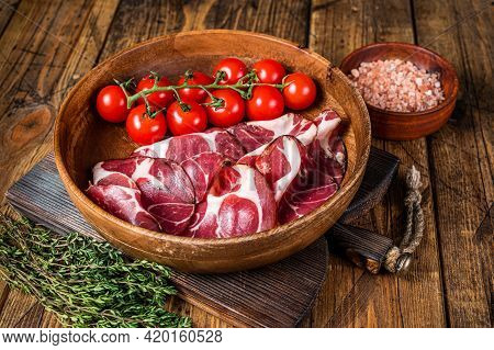 Italian Sliced Cured Coppa Ham With . Wooden Background. Top View