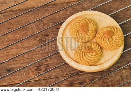 Top View Of Biscoff Butter Cookies On Wooden Plate. Malaysian Traditional Cookies Served During Eid 