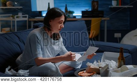 Traumatised, Frustrated Woman Opening Eviction Notice Suffering A Shock