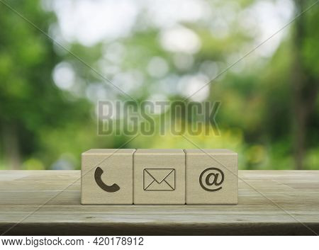 Telephone, Mail, Email Address Icon On Wood Block Cubes On Wooden Table Over Blur Green Tree In Park