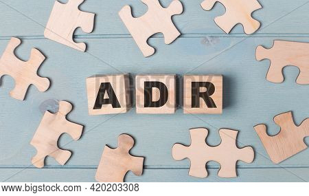 Blank Puzzles And Wooden Cubes With The Text Adr Alternative Dispute Resolution Lie On A Light Blue 