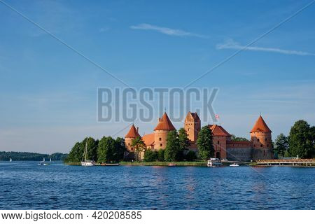 Trakai Island Castle in lake Galve with boats and yachts in summer day with beautiful sky, Lithuania. Trakai Castle is one of major tourist attractions of Lituania