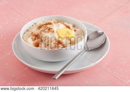 rice pudding with butter cinnamon. french riz au lait, norwegian risgrot, traditional breakfast dessert