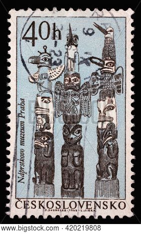 ZAGREB, CROATIA - SEPTEMBER 18, 2014: Stamp printed in Czechoslovakia shows Haida totem poles, Indians of North America series, circa 1966