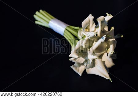 Wedding Bouquet Of White Calla Lilies On A Black Background