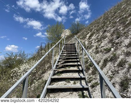 A Staircase Leads To The Top Of A Chalk Hill Past A Rocky Temple Against A Blue Sky In Divnogorye Vo