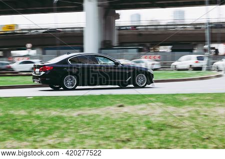 Bmw 520d Xdrive In The City Street. Side View Of Black Mercedes Car Riding On The Road On High Speed