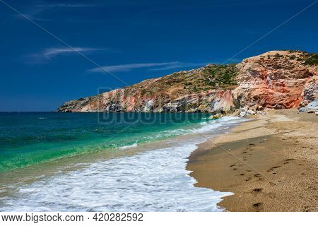 Greek beach in Greece view - Paleochori beach and waves of Aegean sea, Milos island, Cyclades, Greece. Slow motion