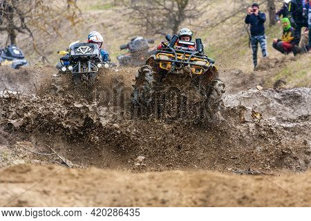 Afipsip, Russia - October 31, 2020: Sportsmen On Quad Bikes Drive Splashing In Dirt And Water At Mud