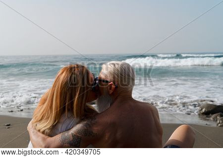 Lifestyle With Caucasian Senior Couple Resting On Beach, Happy In Love Romantic And Relax Time, Tour