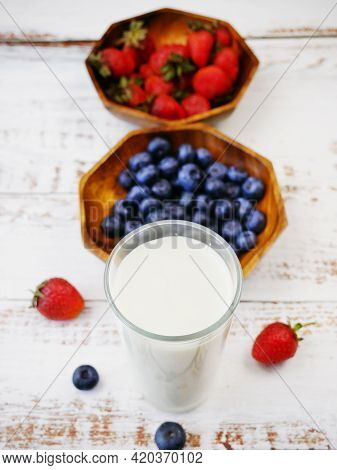Morning Breakfast With Fresh Fruits And Yogurt Or Milk On A White Wooden Background, Closeup