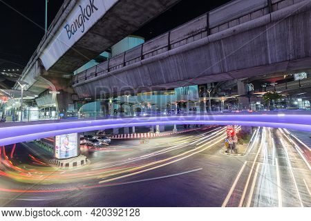 Bangkok Thailand , April 03 , 2021 : Bts Skytrain And Sky Walk Mbk Shopping Center With Car Lights O