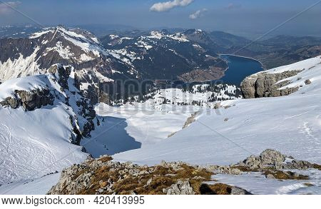 View From The Mutteristock Mountain Peak Of The Wagitalersee In Innerthal. Ski Tour In Winter In The