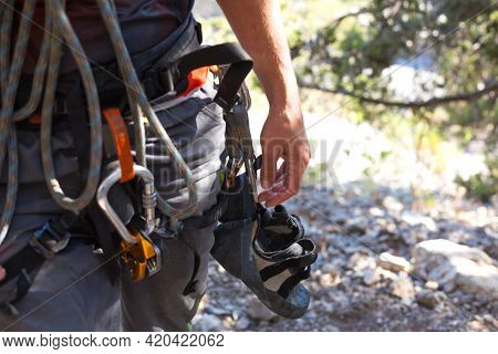 Climbing Equipment On A Male Climber: Rock Shoes, Rope, Quickdraw, Safety Device, Harness. Sports Mo