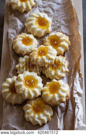 Homemade Shortbread Cookies Qurabiya With Orange Jam In The Center On A Baking Paper. Close-up, Sele