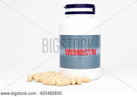 Medical Concept - Ivermectin Bottle With Scattered Capsules. Isolated On White Background.