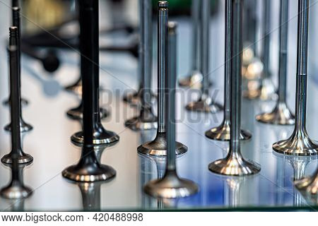 Abstract Background With Car Engine Valves In A Glass Showcase, Close-up