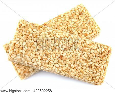 Two Tiles Of Sesame Kozinak Are Isolated On A White Background.