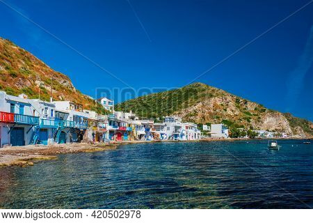 Scenic picturesque greek fishing village Klima with whitewashed traditional houses and colorful windows and doors on Milos island in Greece