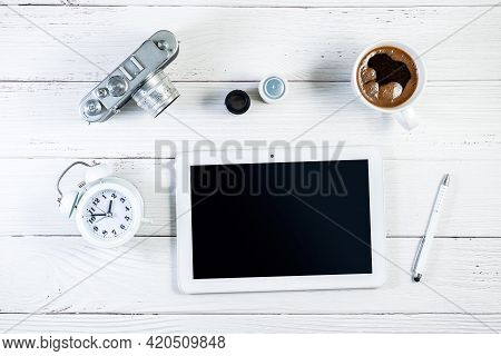 Tablet And Rangefinder Film Camera Photography Setting, With A Cup Of Coffee And Alarm Clock On A Wo