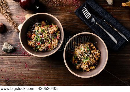 Risotto With Micro-greens. Raw Vegan Vegetable Risotto And Microgreens In Bowl On Rustic Wooden Back