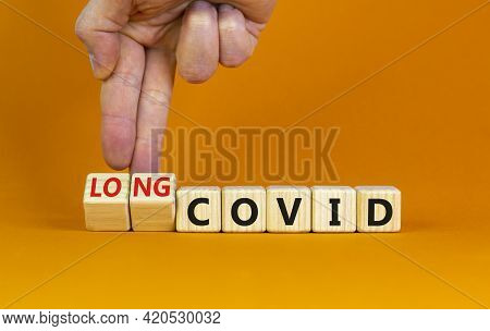 Long Covid Symbol. Doctor Turnes Wooden Cubes And Changes Words 'covid' To 'long Covid'. Beautiful O