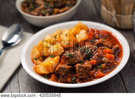 Hot Stew With Mushrooms And Potatoes On A Plate.
