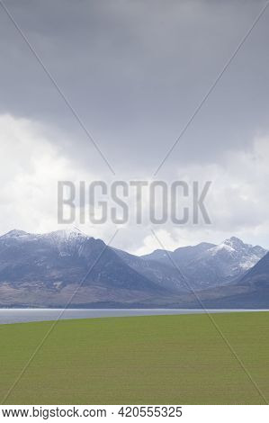 Arran Viewed From Rothesay In Isle Of Bute Under Dark Clouds