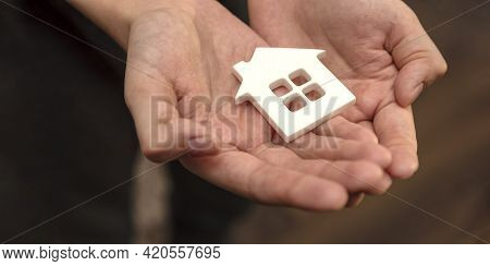 Orphanage, Children In The Orphanage. The Child Is Holding A Small House-shaped Figurine, Close-up. 