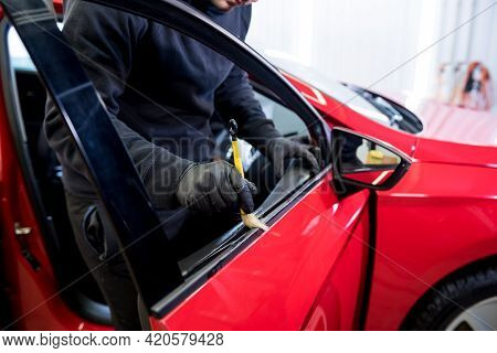 Car Service Worker Cleans Interiror With Special Brush