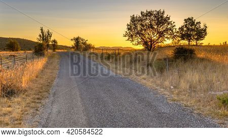Sunrise Over Road In Highland Limestone Karst Plateau Landscape On Causse De Blandas, Occitanie, Fra