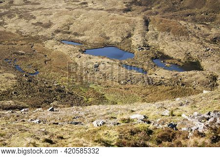 Coum Tay Lakes Seen From The Edge Of The Comeragh Plateau  In County Waterford, Ireland.