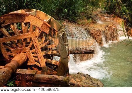 Wooden Water Turbine At Outdoor In Forest Of Tat Kuang Si Waterfalls Or Kuang Xi Falls For Laotian P