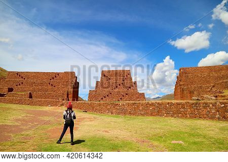 Female Tourist Admiring The Ancient Structures Of Rumicolca,  Amazing Archaeological Site Of Wari Ci