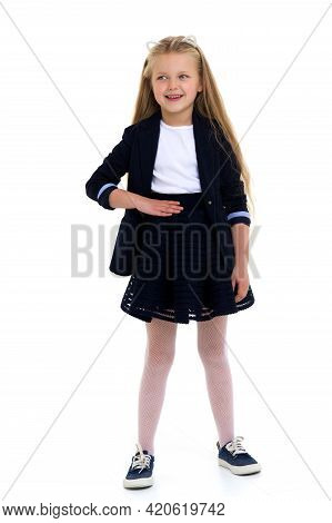 Cute Girl Elementary School Student. Cute Long Haired School Girl Wearing Blue Jacket And Skirt Posi