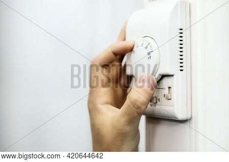Human Hand On The Air Conditioner Temperature Controller. Service For The Installation And Configura