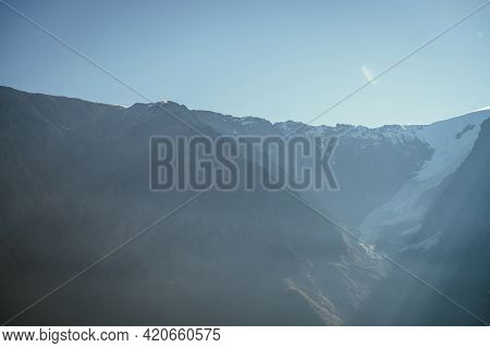 Colorful View To High Silhouettes Of Snowy Mountains And Glacier In Sunlight. Beautiful Sunny Scener